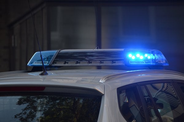 police car flashing blue lights at night